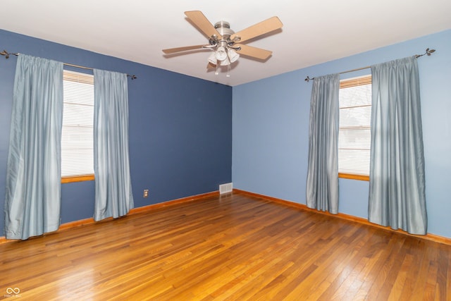 spare room featuring hardwood / wood-style flooring and ceiling fan