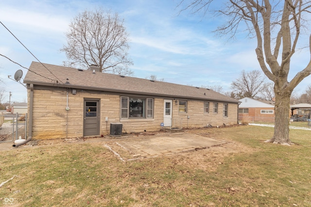 rear view of house featuring a yard, cooling unit, and a patio area