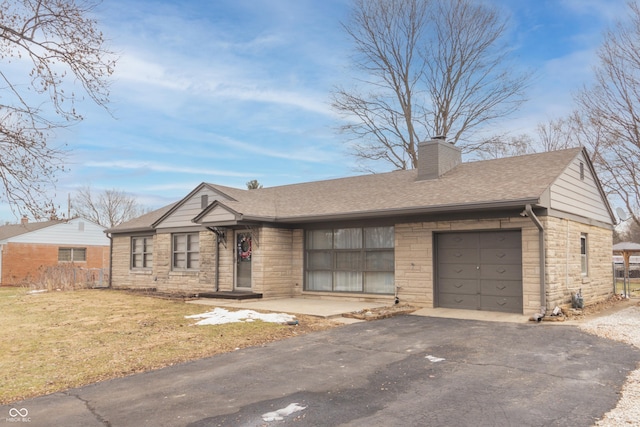 single story home with a garage and a front lawn