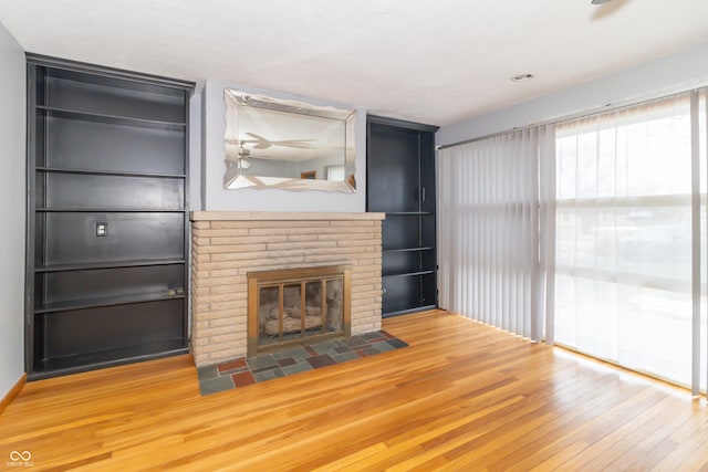 unfurnished living room featuring hardwood / wood-style flooring and a fireplace