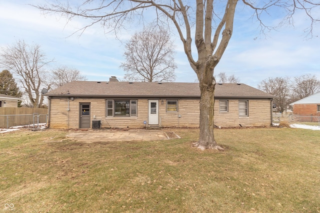 back of property featuring a patio and a yard