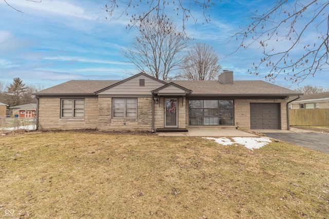 single story home featuring a garage and a front yard