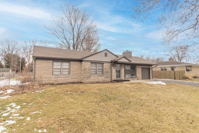 ranch-style home featuring a garage and a front yard