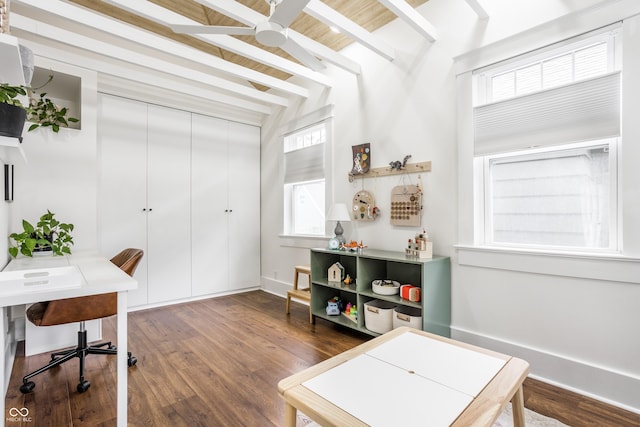 home office featuring beamed ceiling and dark hardwood / wood-style floors