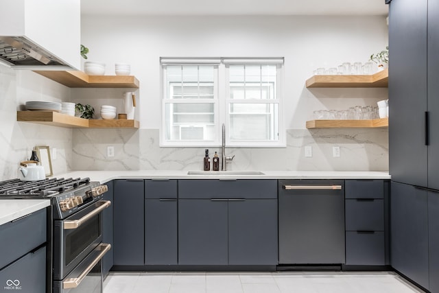 kitchen with tasteful backsplash, dishwasher, sink, range with two ovens, and custom range hood