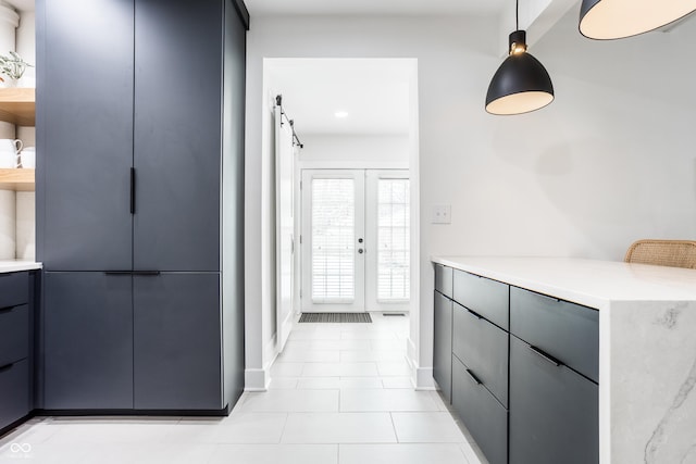 kitchen with french doors, pendant lighting, and light tile patterned floors