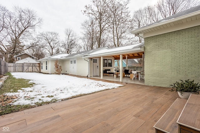 snow covered deck with a patio area