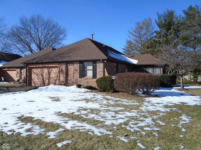 view of snow covered exterior with a garage