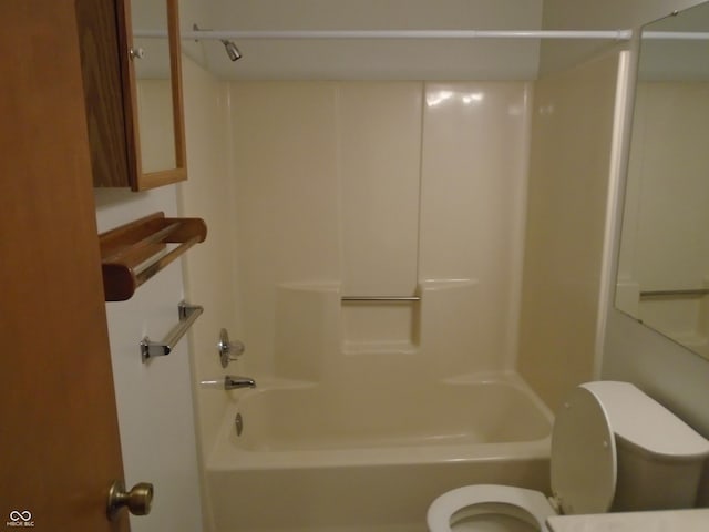 bathroom with bathtub / shower combination and toilet