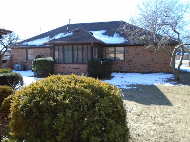 view of snow covered exterior featuring central air condition unit