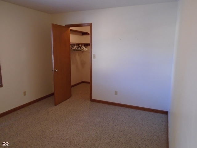 unfurnished bedroom with a walk in closet and a closet