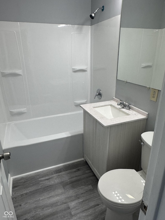 full bathroom with vanity, hardwood / wood-style flooring, shower / tub combination, and toilet