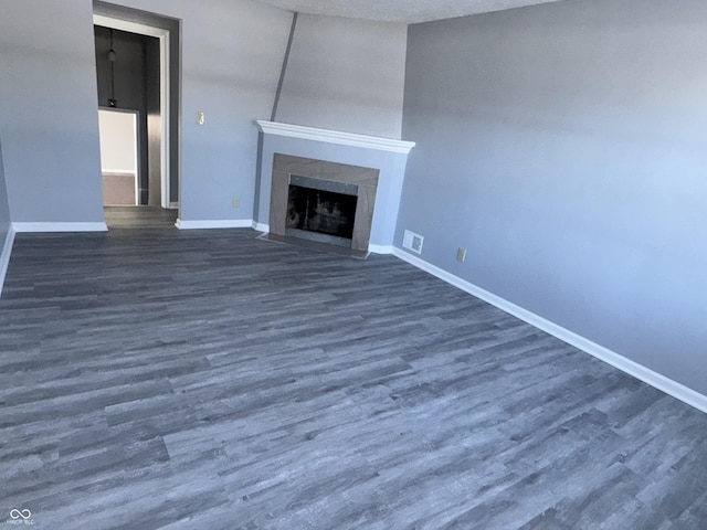 unfurnished living room with dark wood-type flooring