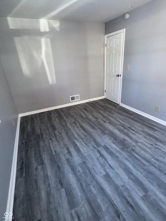 empty room featuring dark hardwood / wood-style flooring