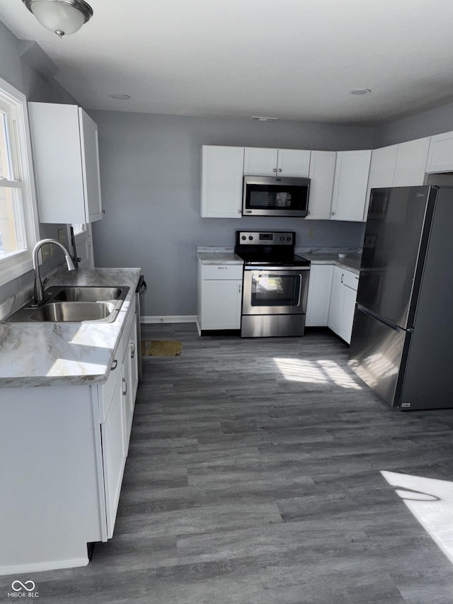 kitchen featuring sink, dark hardwood / wood-style floors, white cabinets, and appliances with stainless steel finishes