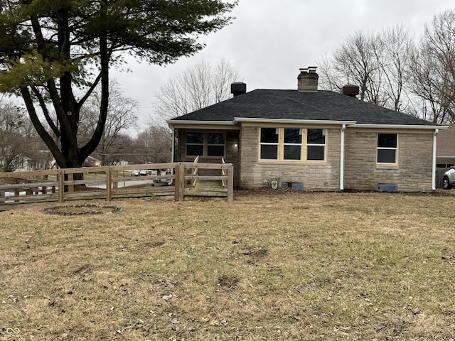 back of property with a lawn