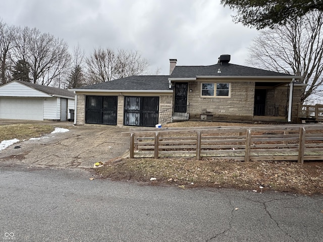 view of front of house with a garage and an outdoor structure