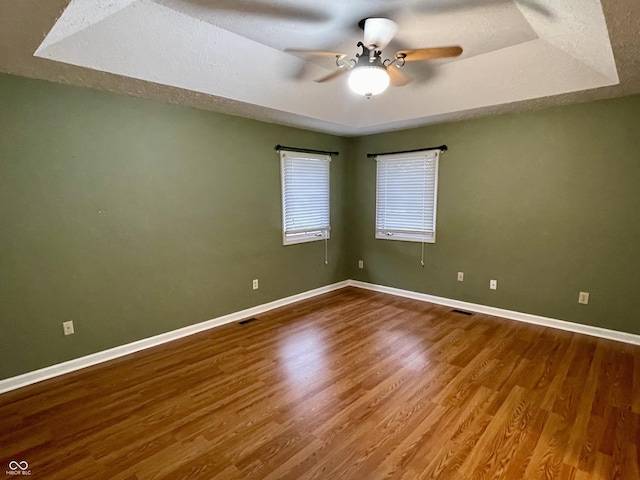 empty room with hardwood / wood-style flooring and ceiling fan