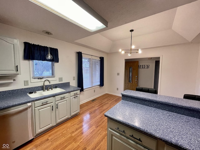 kitchen with sink, dishwasher, light hardwood / wood-style floors, vaulted ceiling, and a chandelier