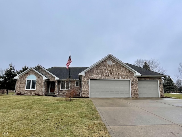 ranch-style house featuring a garage and a front lawn