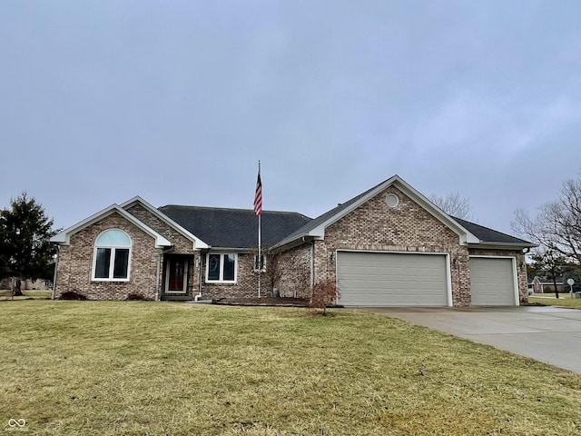 ranch-style house featuring a garage and a front yard