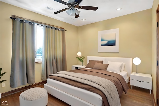 bedroom featuring ceiling fan and dark hardwood / wood-style flooring