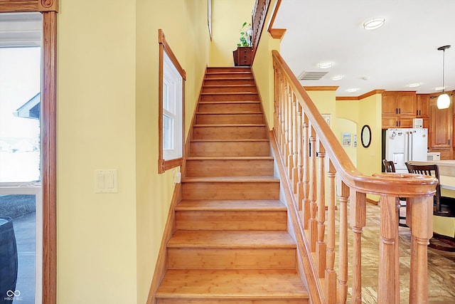 stairs with wood-type flooring and a wealth of natural light