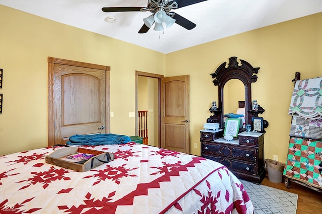 bedroom with hardwood / wood-style floors and ceiling fan