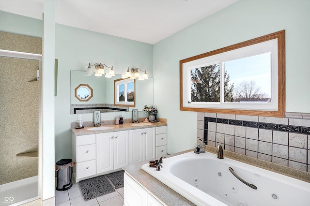 bathroom with tile patterned floors, vanity, and tiled tub