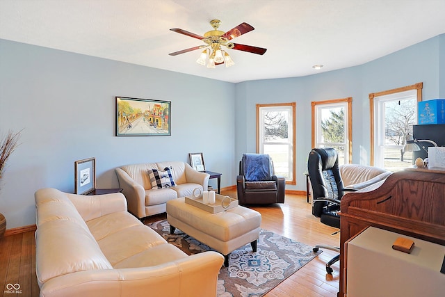 home office featuring a wealth of natural light, light hardwood / wood-style floors, and ceiling fan