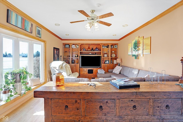 living room featuring crown molding, ceiling fan, and light wood-type flooring