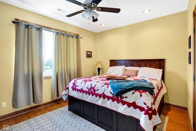 bedroom with hardwood / wood-style flooring and ceiling fan