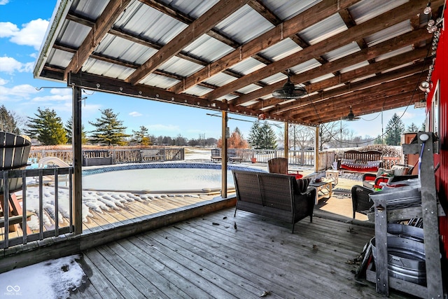 wooden deck featuring an empty pool, an outdoor living space, and ceiling fan