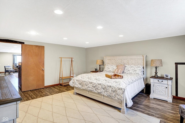 bedroom with wood-type flooring and a textured ceiling