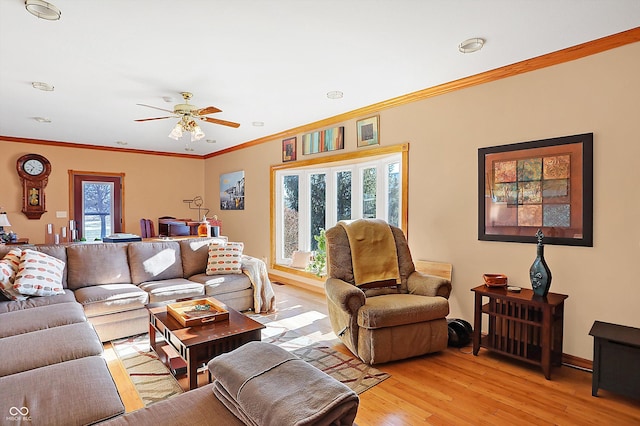 living room with light hardwood / wood-style flooring, ornamental molding, and ceiling fan