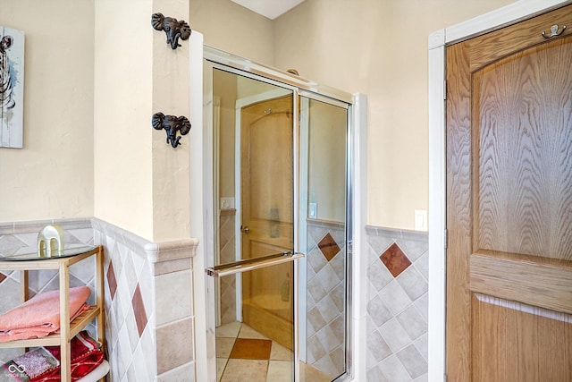 bathroom with tile walls and tile patterned floors