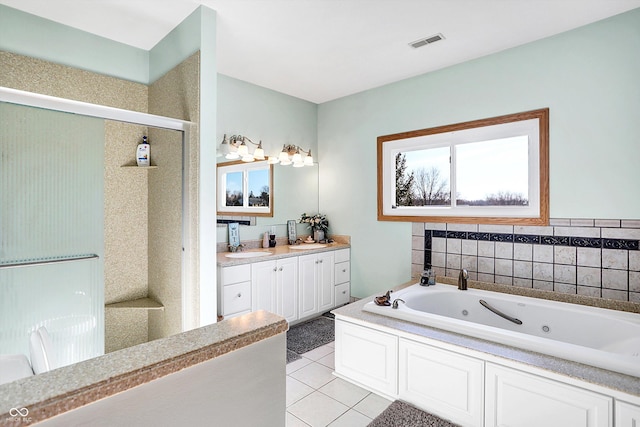 bathroom featuring vanity, a tub, and tile patterned floors