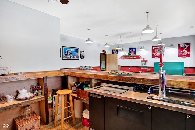 kitchen with pendant lighting, wood-type flooring, and ceiling fan