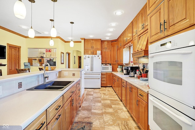 kitchen featuring pendant lighting, sink, white appliances, ornamental molding, and custom exhaust hood