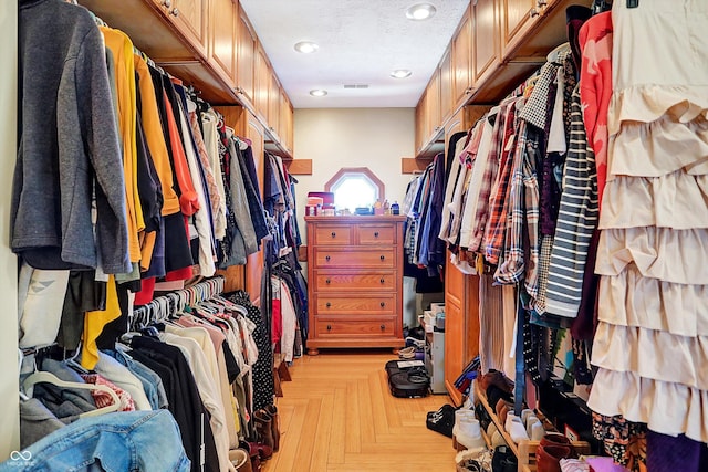 walk in closet featuring light parquet flooring