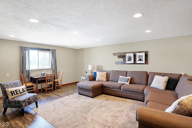 living room featuring hardwood / wood-style flooring and a textured ceiling