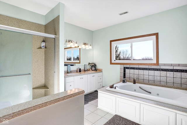 bathroom with independent shower and bath, vanity, and tile patterned floors