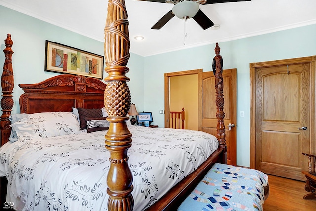 bedroom with crown molding, ceiling fan, and hardwood / wood-style flooring