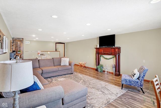 living room with hardwood / wood-style flooring and a textured ceiling