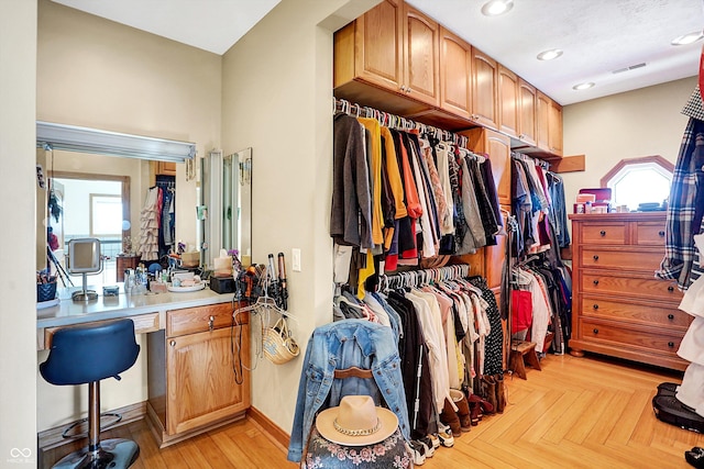 walk in closet featuring light parquet flooring