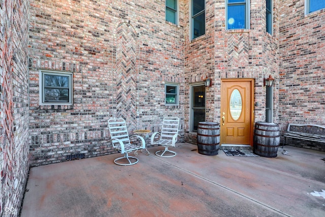 entrance to property featuring a patio