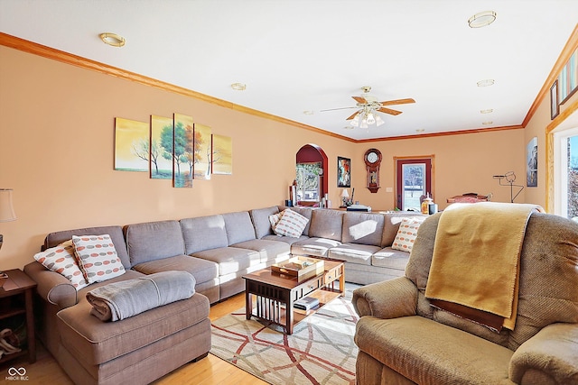 living room featuring ornamental molding, ceiling fan, and light hardwood / wood-style flooring