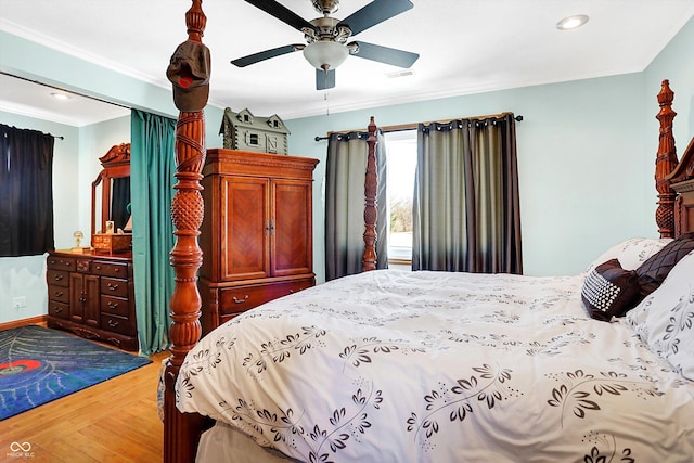 bedroom featuring hardwood / wood-style flooring, ceiling fan, and crown molding