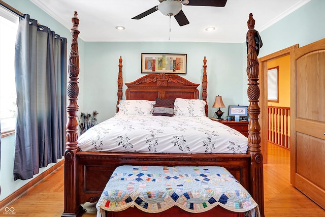 bedroom featuring ceiling fan, ornamental molding, and light wood-type flooring