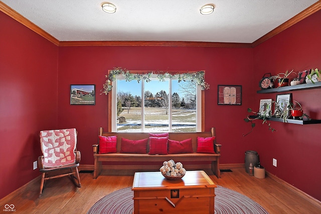 living room with hardwood / wood-style flooring, crown molding, and a textured ceiling